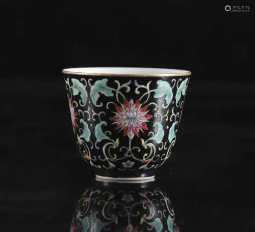 A Chinese famille noire 'Lotus scroll' tea cup, Yongzheng ma...