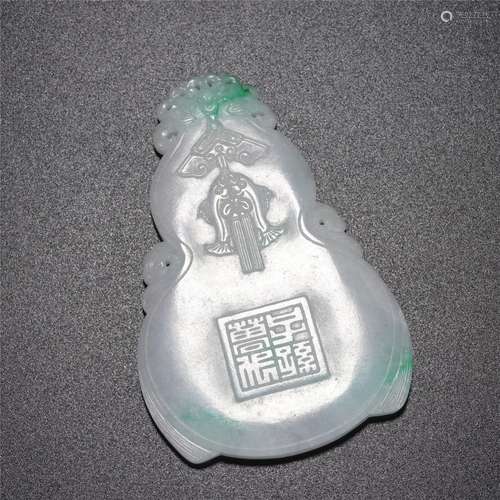 A CARVED JADEITE PENDANT