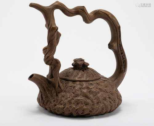 A Qing Dynasty purple clay teapot with a handle