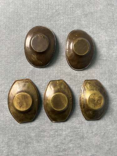 A set of late Qing dynasty brass tea cup holders