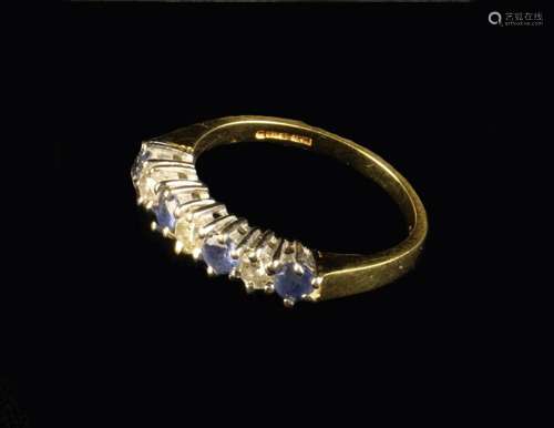 An 18 Carat Gold Ring set with three diamonds and four small...