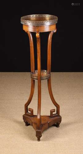 A Mahogany Torchère Stand. The round leather clad top emboss...