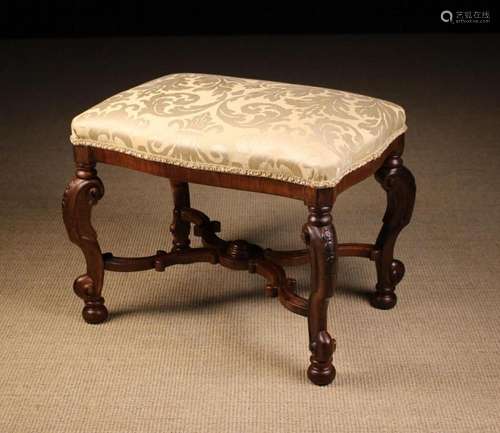 A Queen Anne Style Walnut Stool. The serpentine edged seat w...