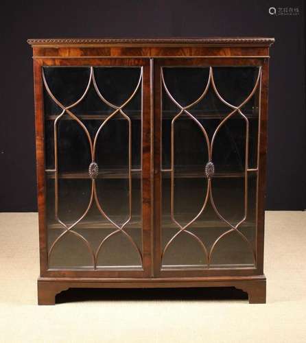 A Vintage Mahogany Display Cabinet. The top having carved ri...