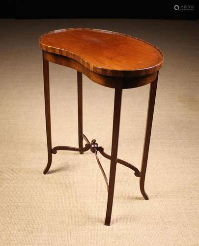 A Small Kidney Shaped Mahogany Table. The top edged with che...