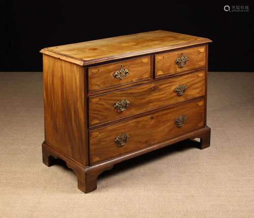 A George III Mahogany Chest of Drawers. The two short over t...