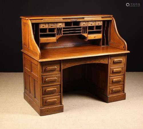 A Vintage Oak Roll Top Desk. The top section having a down-s...