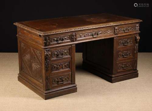 A Victorian Carved Oak Pedestal Desk. The rectangular top wi...