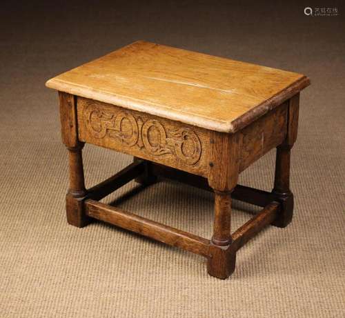 An Old Oak Box Stool (A/F). The hinged rectangular lid enclo...