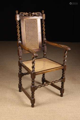 A Caned Barleytwist Armchair of Charles II style inspired de...