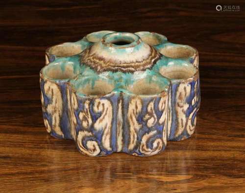 A Lobed Iznik Pot with nine cylindrical chambers around a ce...