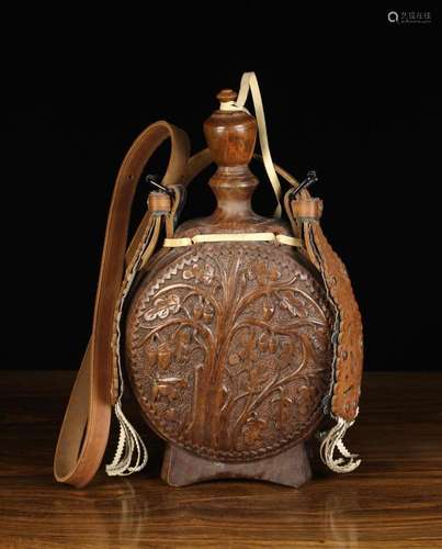 A Large Carved Wooden Pilgrim's Flask. The lenticular si...