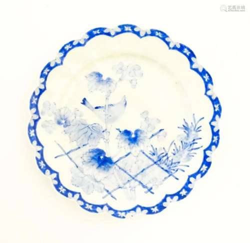 A Japanese blue and white plate with scalloped edge, decorat...