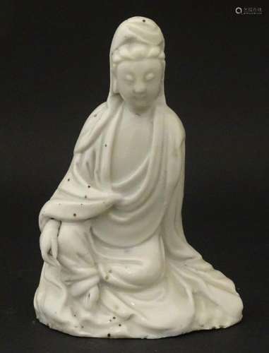 A Chinese blanc de chine figure modelled as Guanyin seated. ...