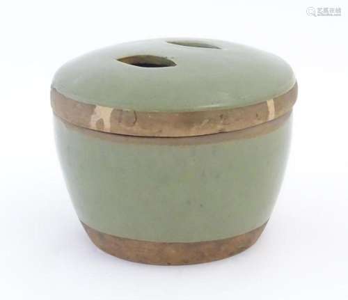 A Chinese celadon pot and cover. Character marks under. Appr...