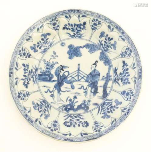A Chinese blue and white plate / dish decorated with two lad...