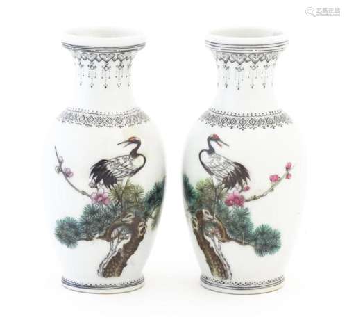 A pair of Chinese vases each decorated with a crane bird per...