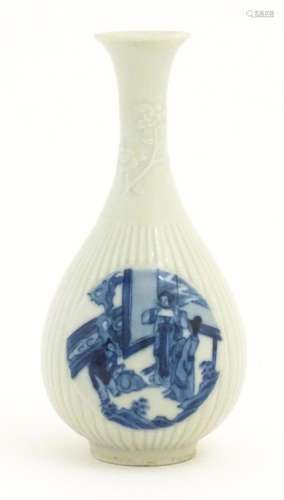 A Chinese blue and white bottle vase with fluted detail deco...
