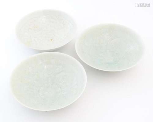 Three Chinese celadon bowls of conical form with incised dec...