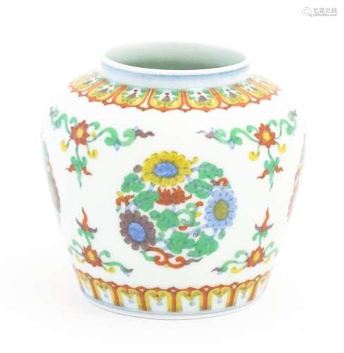 A Chinese vase / jar decorated with roundels of flowers and ...