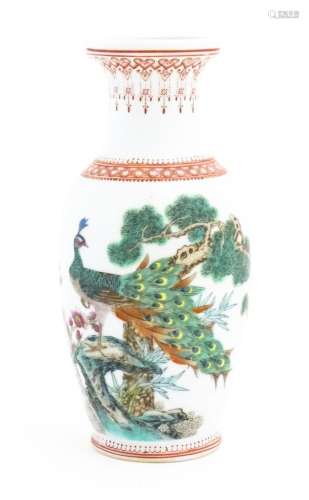 A Chinese vase decorated with a peacock perched on a branch ...