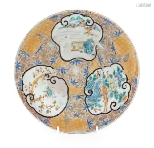 An Oriental plate with stylised panel decoration depicting l...