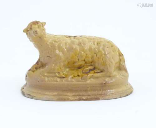 A 19thC ceramic money box modelled as a recumbent sheep. App...