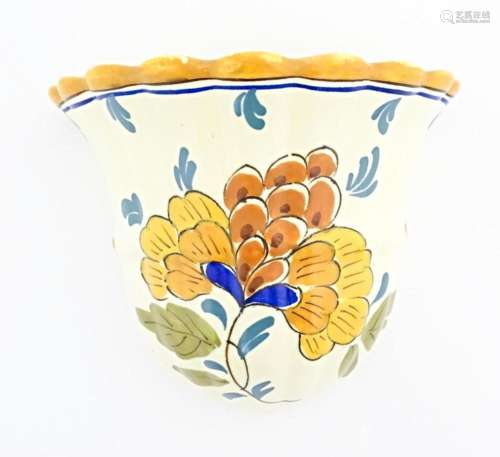 A Dutch wall vase / pocket decorated with flowers and foliag...