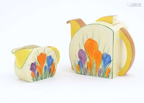 A Clarice Cliff teapot and milk jug decorated in the Crocus ...