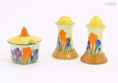 A Clarice Cliff three piece cruet comprising salt, pepper an...