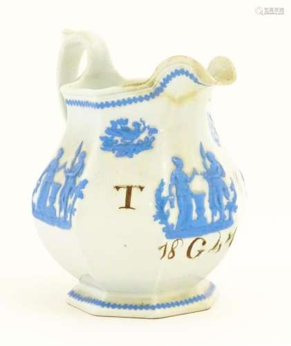A Victorian marriage jug, the cream ground decorated in blue...
