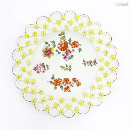 A Derby spectacle plate with pierced border moulded with flo...