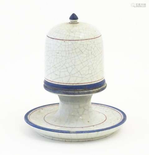 A ceramic table top vesta / match keep of pedestal form with...
