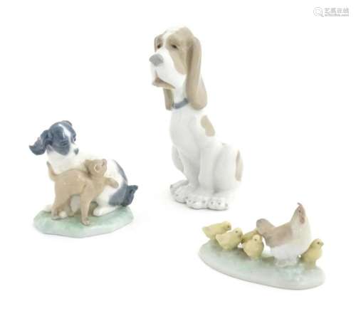Three Nao models of animals comprising a Basset Hound, a dog...