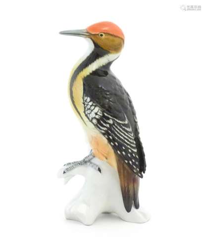 A Karl Ens model of a Woodpecker perched on a branch. Marked...