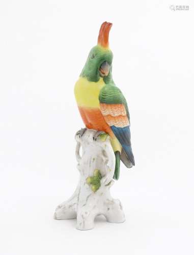 A Capodimonte model of a Parrot with green, yellow, red and ...