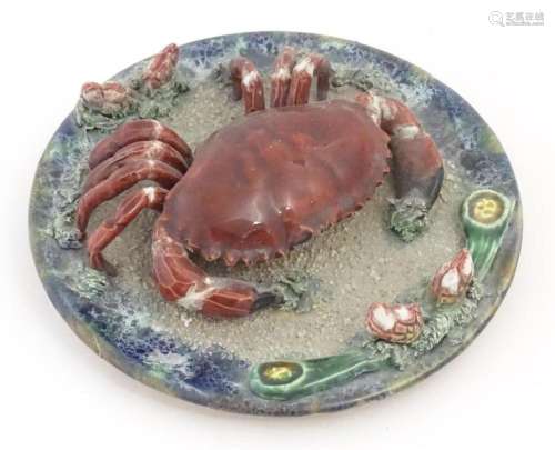 A Palissy style plate with relief crab and shell detail. App...