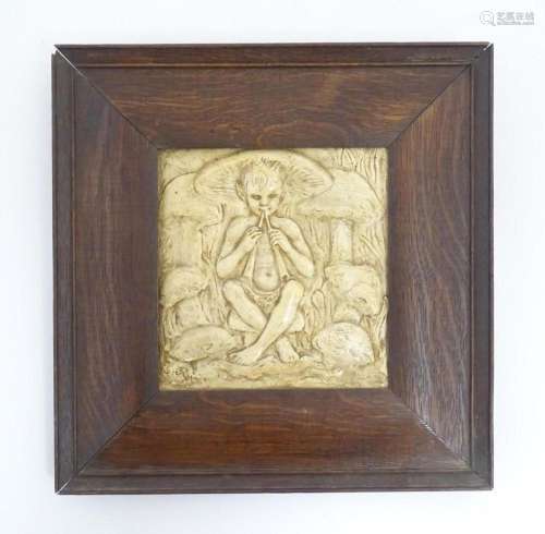 An early 20thC tile with relief decoration depicting the fig...
