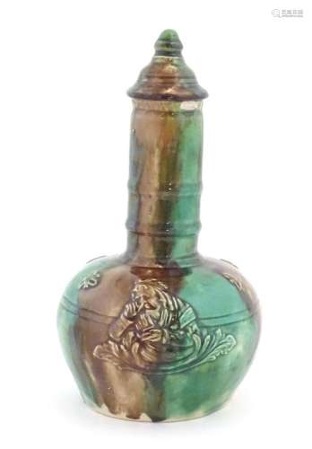 A majolica bottle vase and cover with relief decoration depi...