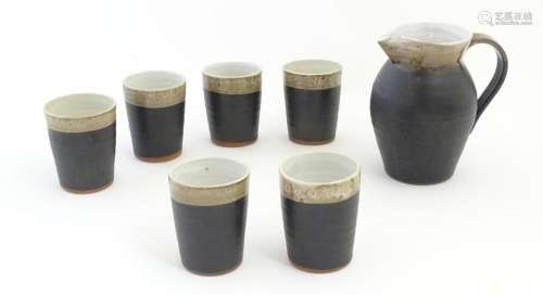 An Irish Shanagarry Pottery jug and six beakers by Stephen P...