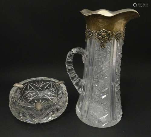 A cut glass jug with American Sterling silver mounts by Gorh...