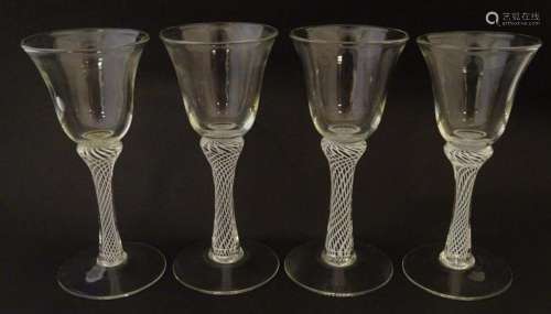 Four various drinking glasses with coloured twist decoration...