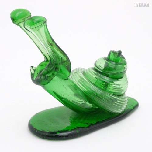 A green glass model of a snail. Approx. 5 3/4" high