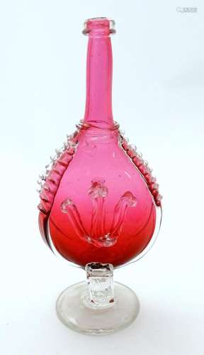 A 19thC red glass bottle vase with clear pedestal foot with ...