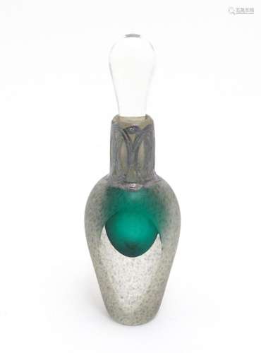 A scent / perfume bottle with green detail and silver overal...