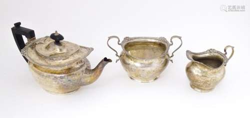 A Victorian silver three piece tea set comprising teapot, mi...