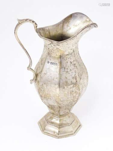 A silver jug of hexagonal baluster form. hallmarked Sheffiel...