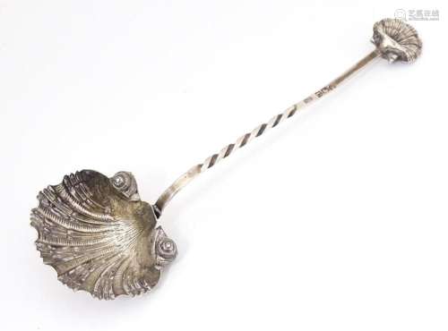 A Victorian silver preserve / sugar spoon with scallop shell...