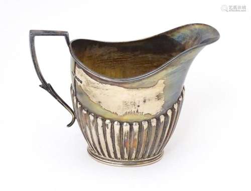 A silver cream jug hallmarked Sheffield 1905 maker James Dix...