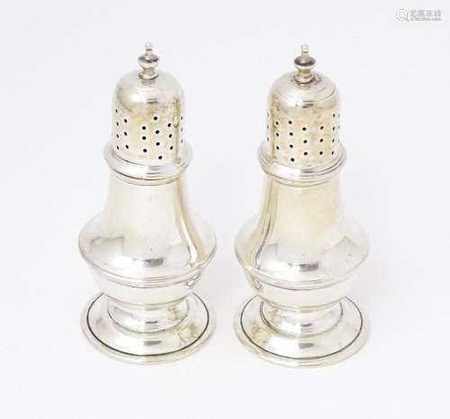 A pair of silver pepperettes hallmarked Chester 1919, maker ...